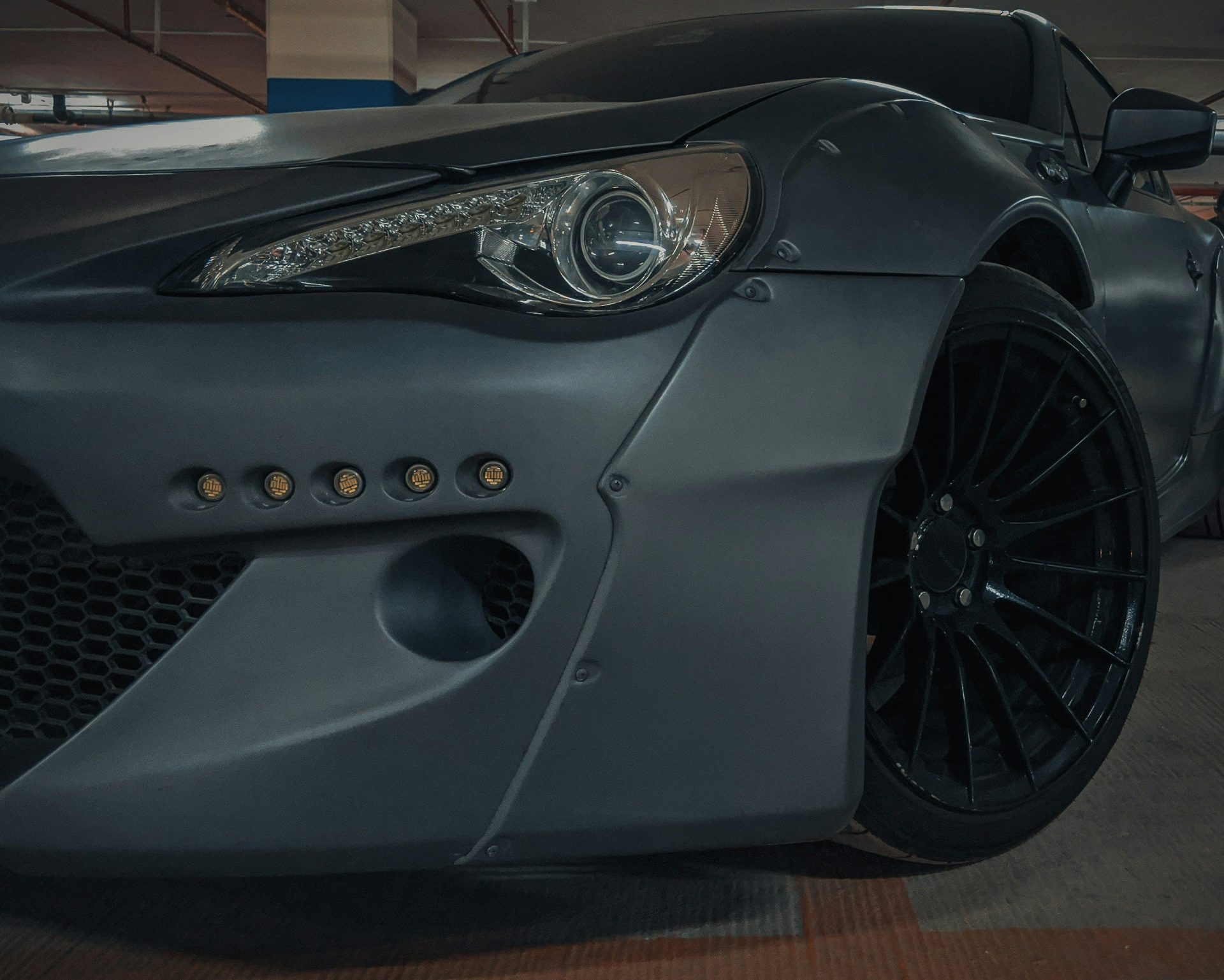 grey porsche 911 parked in garage