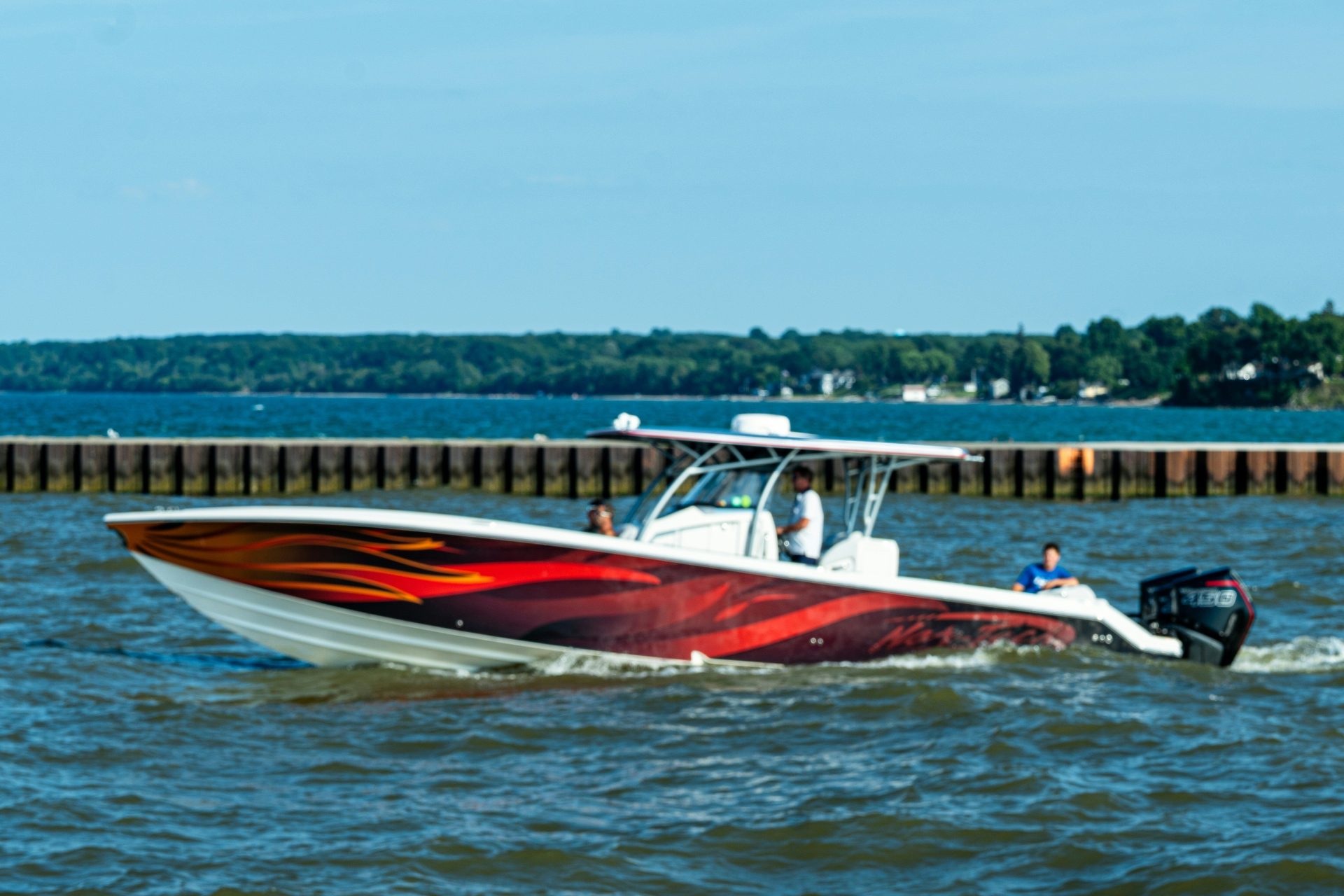 A modern speedboat with a colorful design cruises on water
